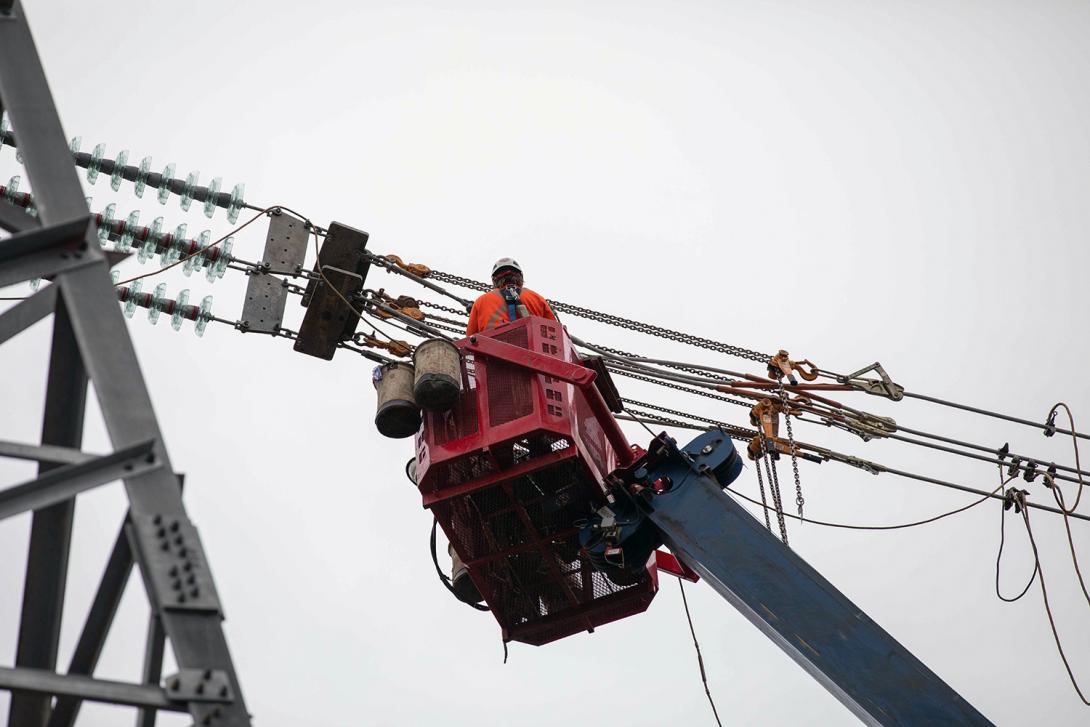 Crews connect, or “clip,” conductors to the insulators. | September 2021