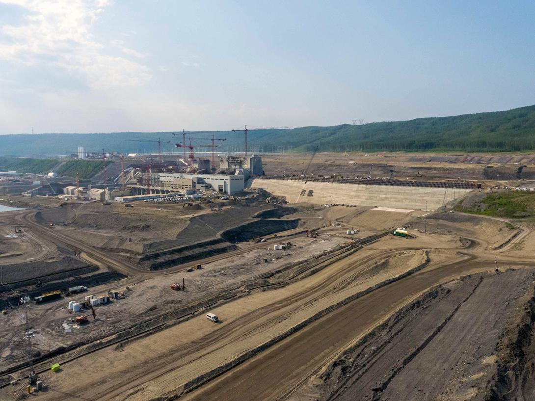 The dam buttress will reach the height of the Unit 1 intake gate behind the service bay of the generating station. | June 2021