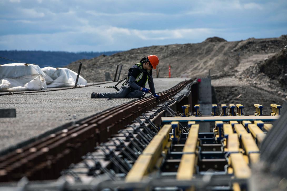 A worker prepares the bridge girder for formwork installation at Cache Creek. | April 2022