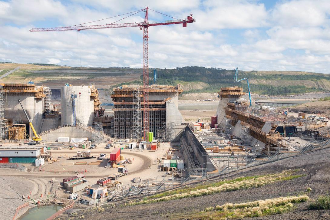 Upstream view of crews working on the right spillway wall. | August 2022