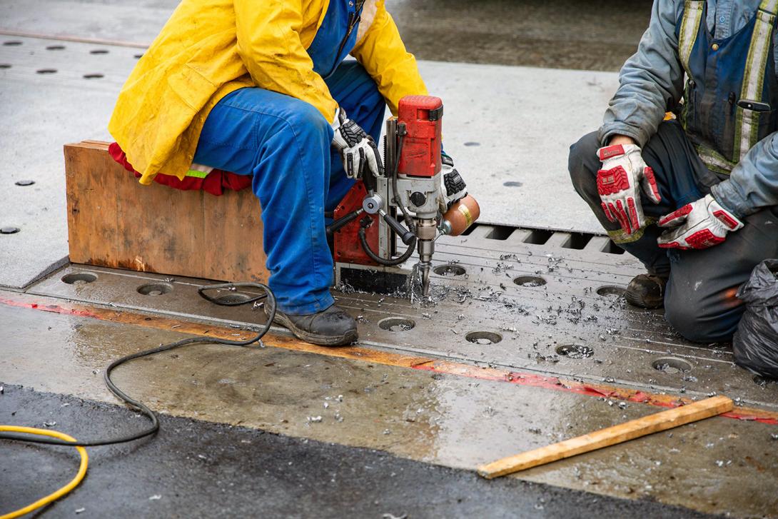 Drilling holes for the expansion joint cover plate at the Farrell Creek Bridge. | October 2022