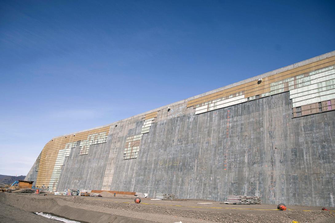 The initial concrete curing of the roller compacted concrete buttress is complete. We’re removing the insulating panels to patch and finish the concrete. | April 2023