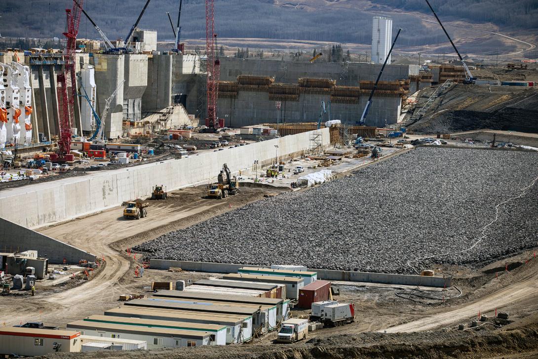 A partially completed section of the approach channel lining, with riprap cover and granular fill. | April 2023