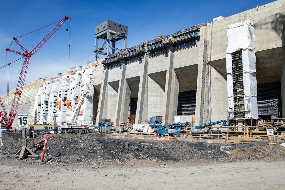 The guides for the trash racks are installed behind the white hoardings. Trash racks stop large debris from entering the intakes. | April 2023