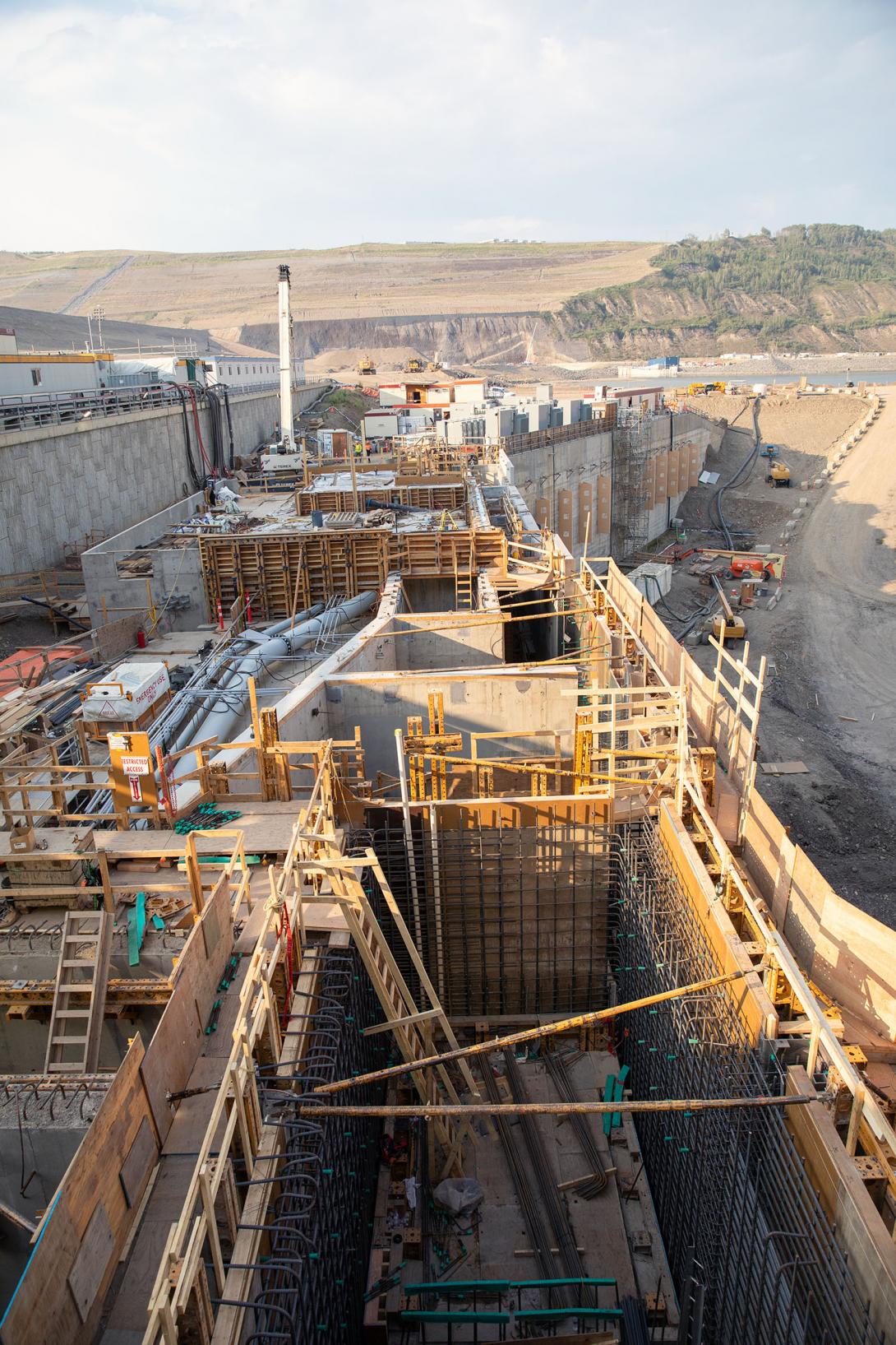 Top view of the permanent fish passage facility, located at the tailrace where migrating fish are attracted to fast water. Inside the facility, fish will be weighed, measured, tagged, and sorted. They are then transported for release upstream of the dam. | July 2023