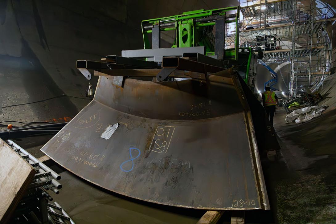 A forklift moves a section of the restricting plate in the diversion tunnel. | July 2023