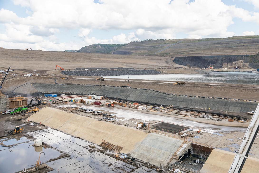 The outer weir is on the outside, or downstream, of the stilling basin weir. Water exiting the spillways is slowed by these two weirs before entering the Peace River.